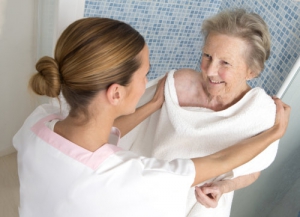 care giver assisting elderly women for shower